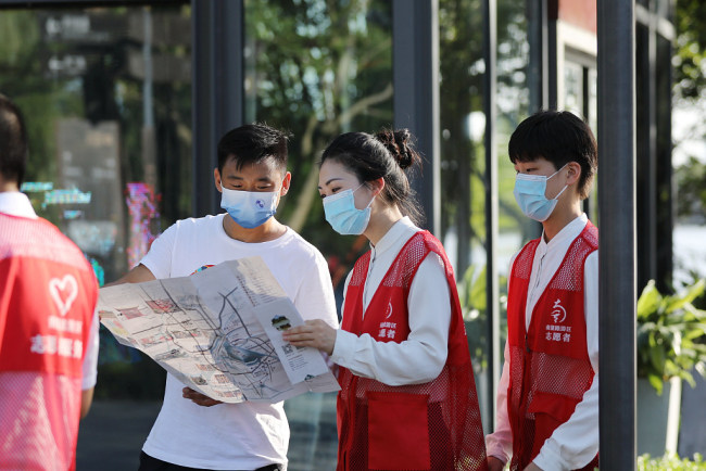 Vullnetarë partiakë ndihmojnë turistët, qytet Jiaxing, provincë Zhejiang,1 korrik(Foto:VCG)