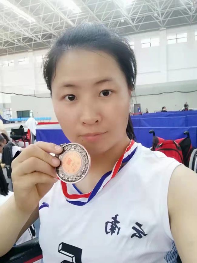 Η Γιανγκ Χονγκτσιόνγκ ποζάρει με το χάλκινο μετάλλιο στο μπάσκετ με αναπηρικό αμαξίδιο. /ευγενική προσφορά του Yang Hongqiong